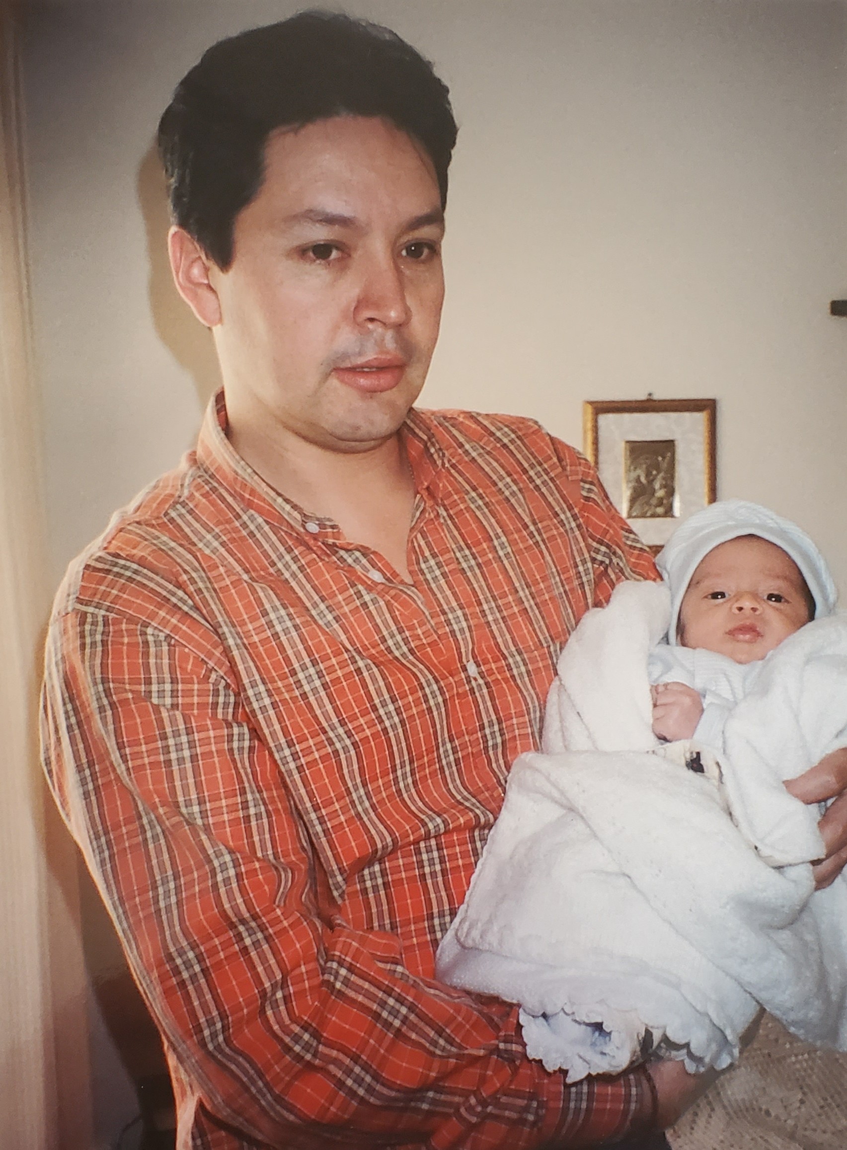 Felipe as a baby with his father